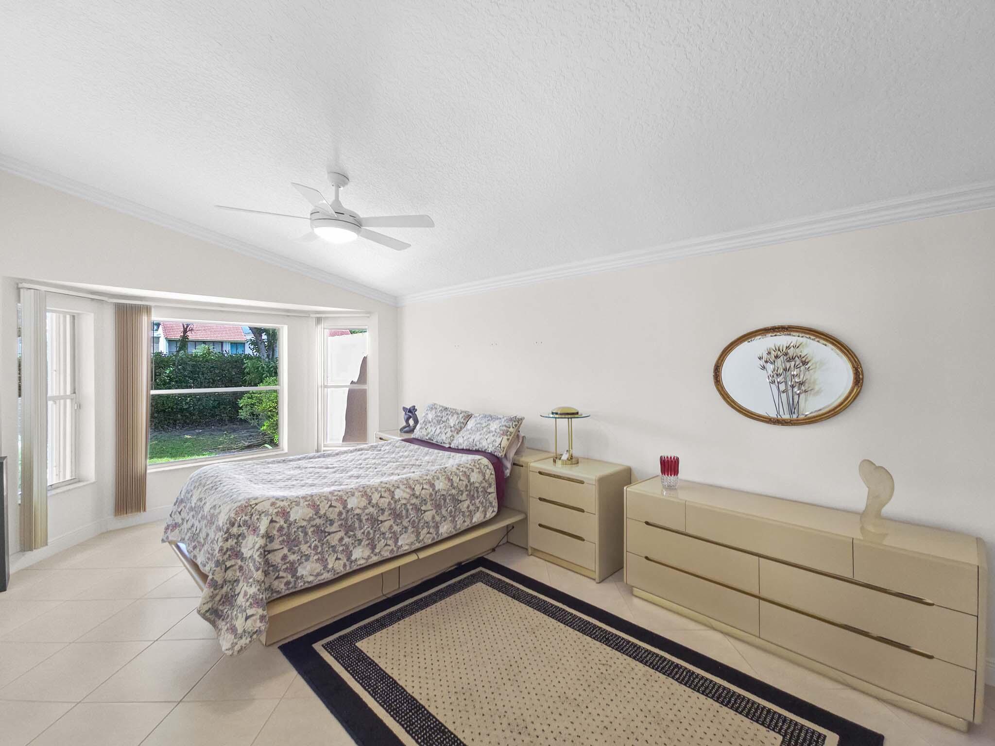 11853 Grove Ridge Lane Boynton Beach, FL 33437 - Photo 27 of 59 a bedroom with a bed and a window