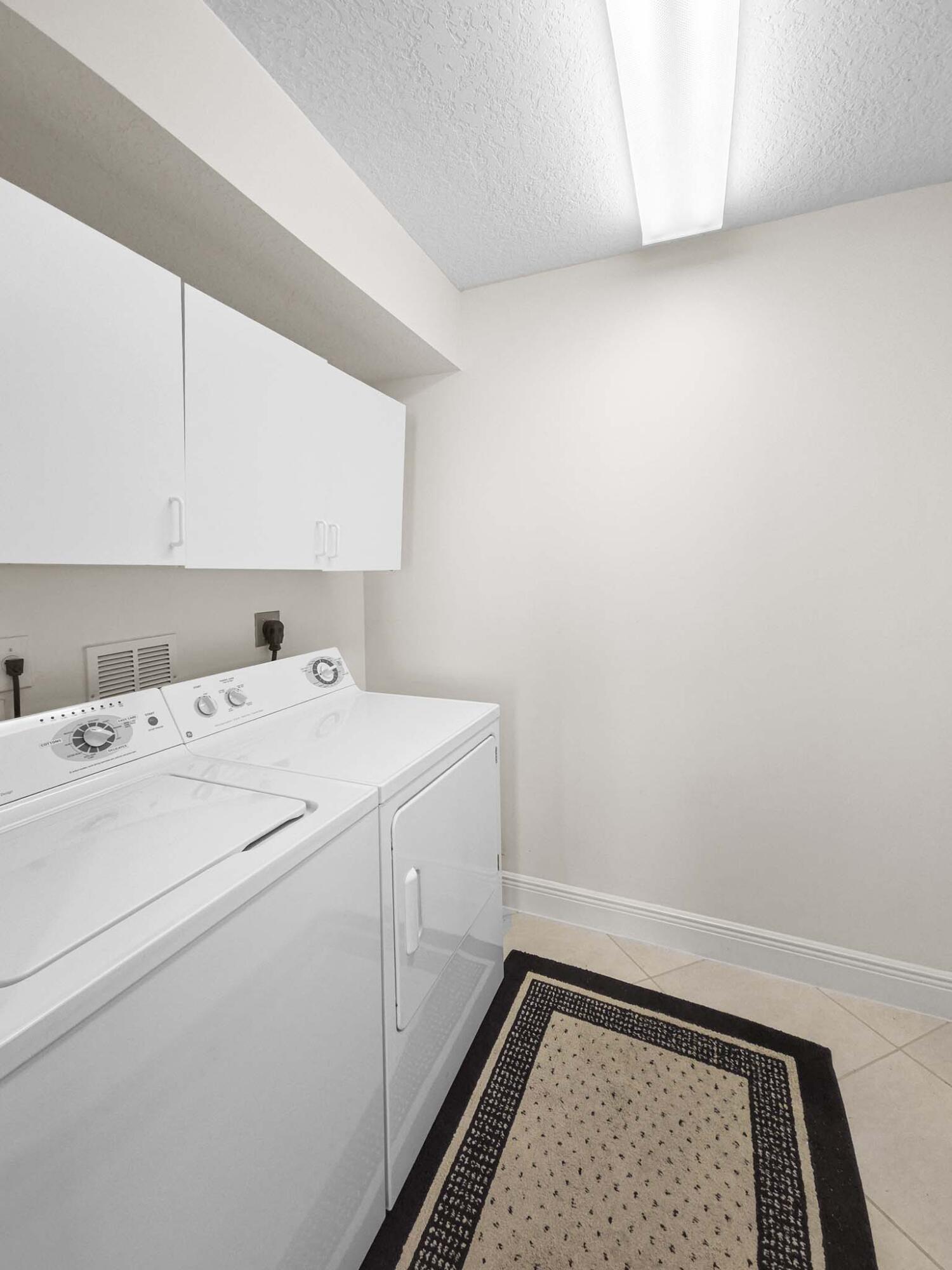 11853 Grove Ridge Lane Boynton Beach, FL 33437 - Photo 6 of 59 a utility room with dryer and washer