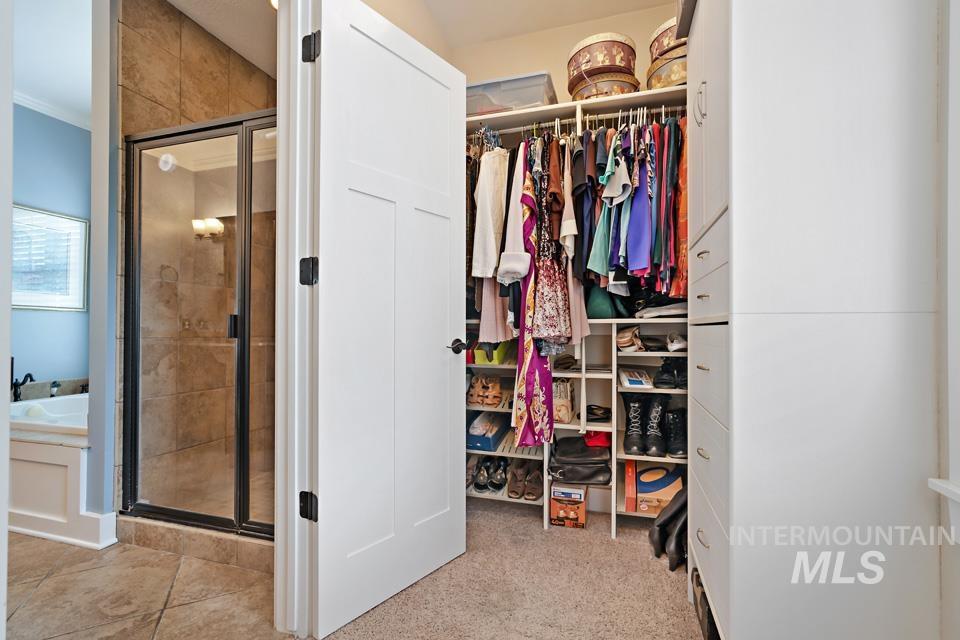 8271 Washoe Road Fruitland, ID 83619 - Photo 24 of 29 Walk-in closet featuring white built-in shelving, hanging rods, and drawers