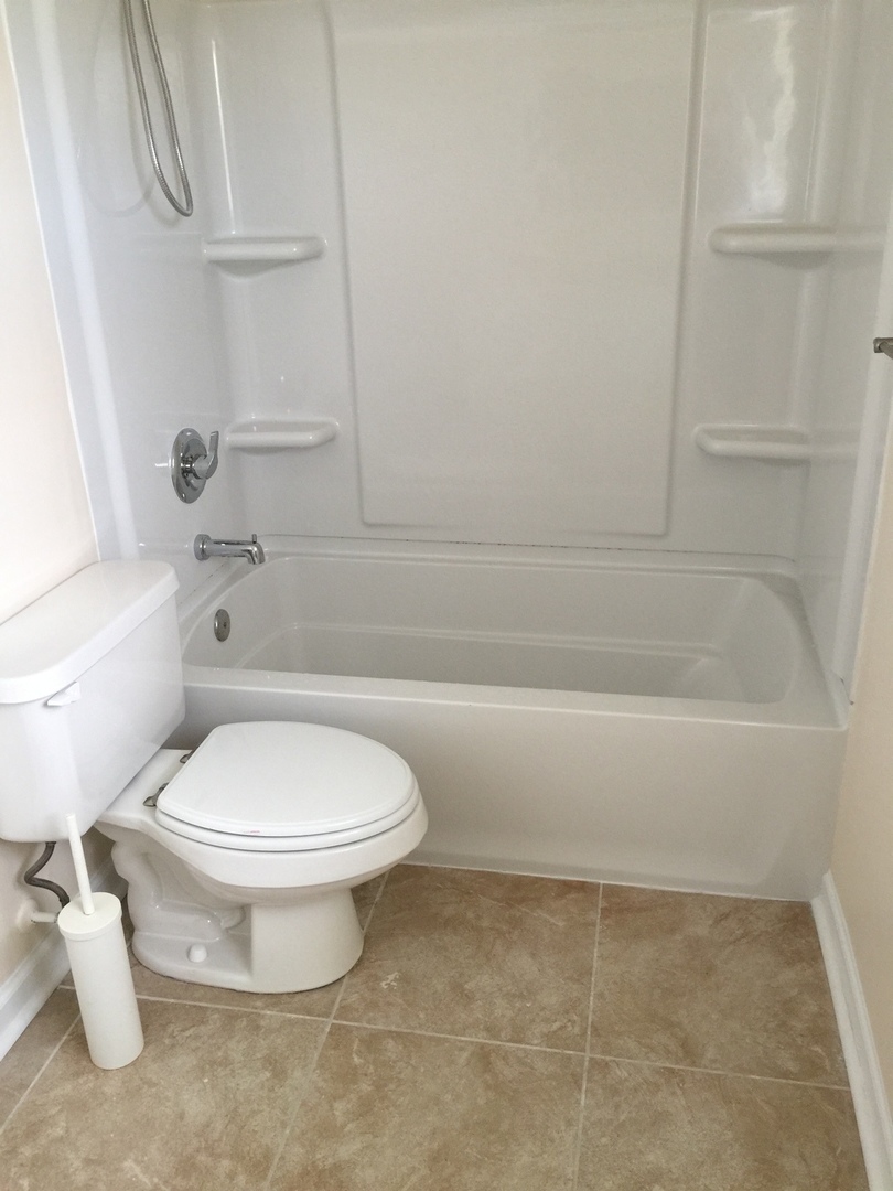 8010 West Lyons Street, Unit B Niles, IL 60714 - Photo 15 of 19 a bathroom with a toilet and a bath tub