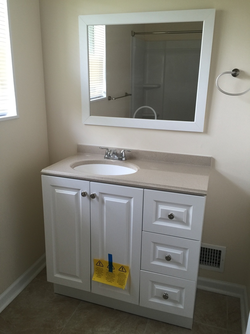 8010 West Lyons Street, Unit B Niles, IL 60714 - Photo 16 of 19 a bathroom with a sink and a mirror