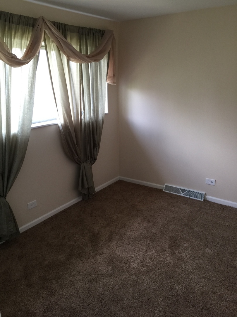 8010 West Lyons Street, Unit B Niles, IL 60714 - Photo 9 of 19 an empty room with a window