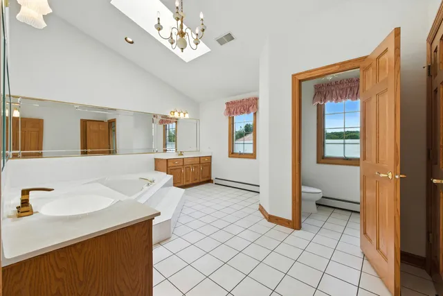 a view of a livingroom with wooden floor and kitchen space
