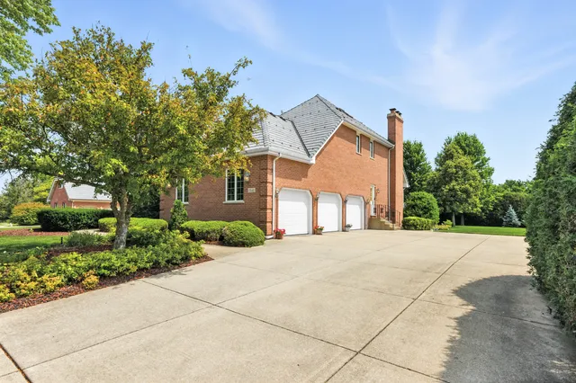 a front view of a house with a yard and a garage