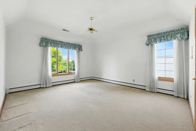 an empty room with windows and closet