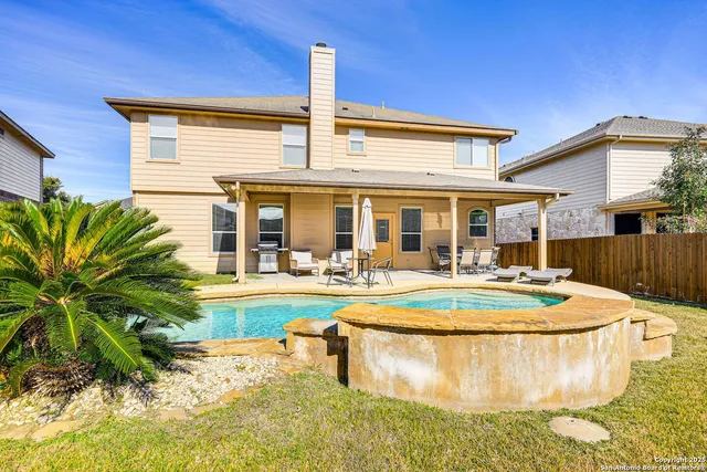 a view of a house with swimming pool and sitting area