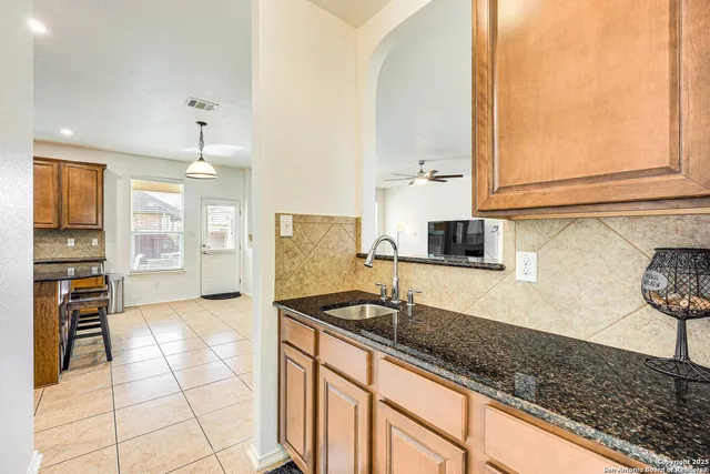 a kitchen with stainless steel appliances granite countertop a sink and a stove