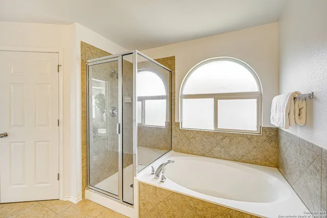 a bathroom with a tub and a shower