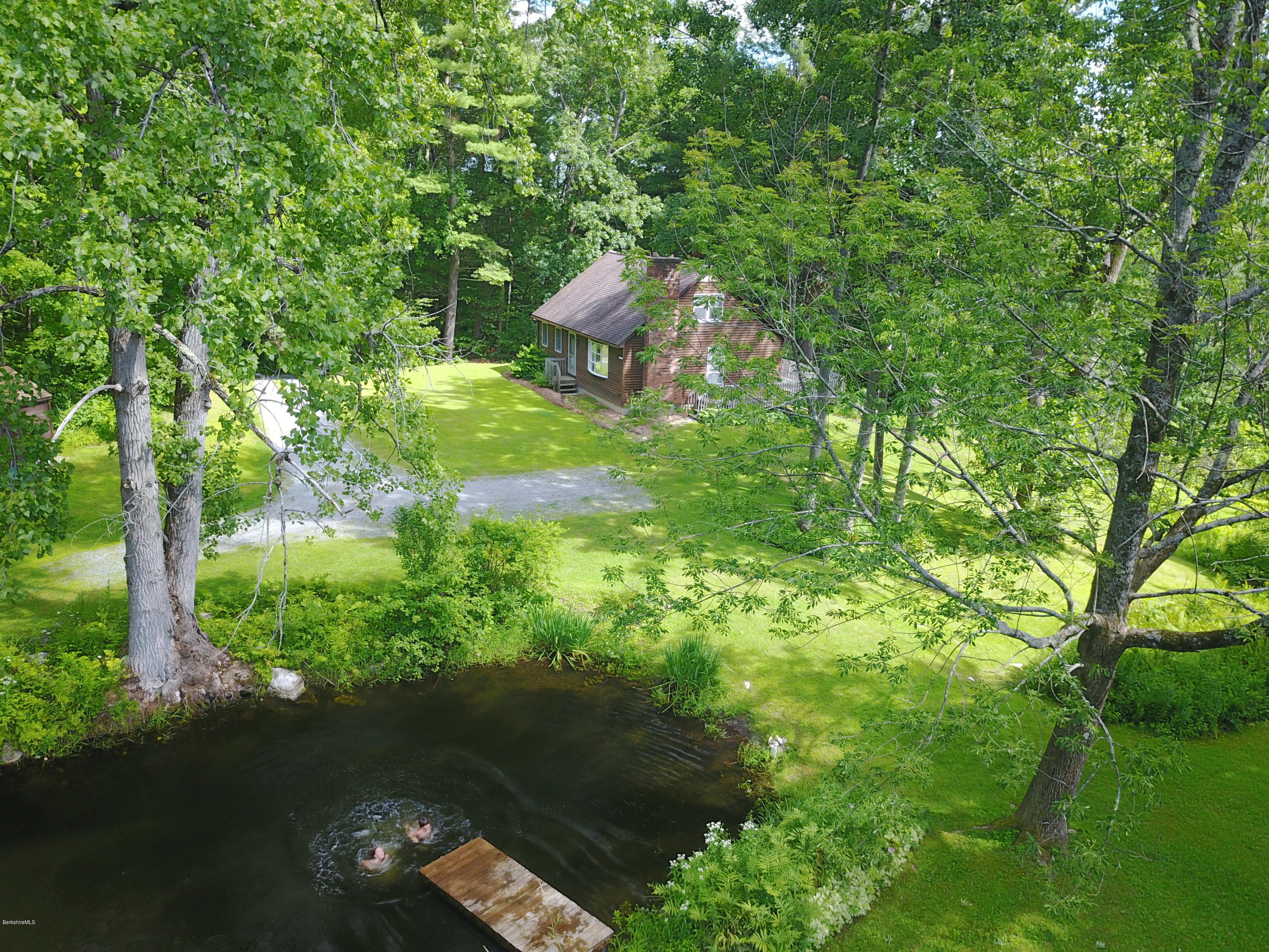 51 Main Road Monterey, MA 01230 - Photo 1 of 17 a backyard of a house with lots of green space