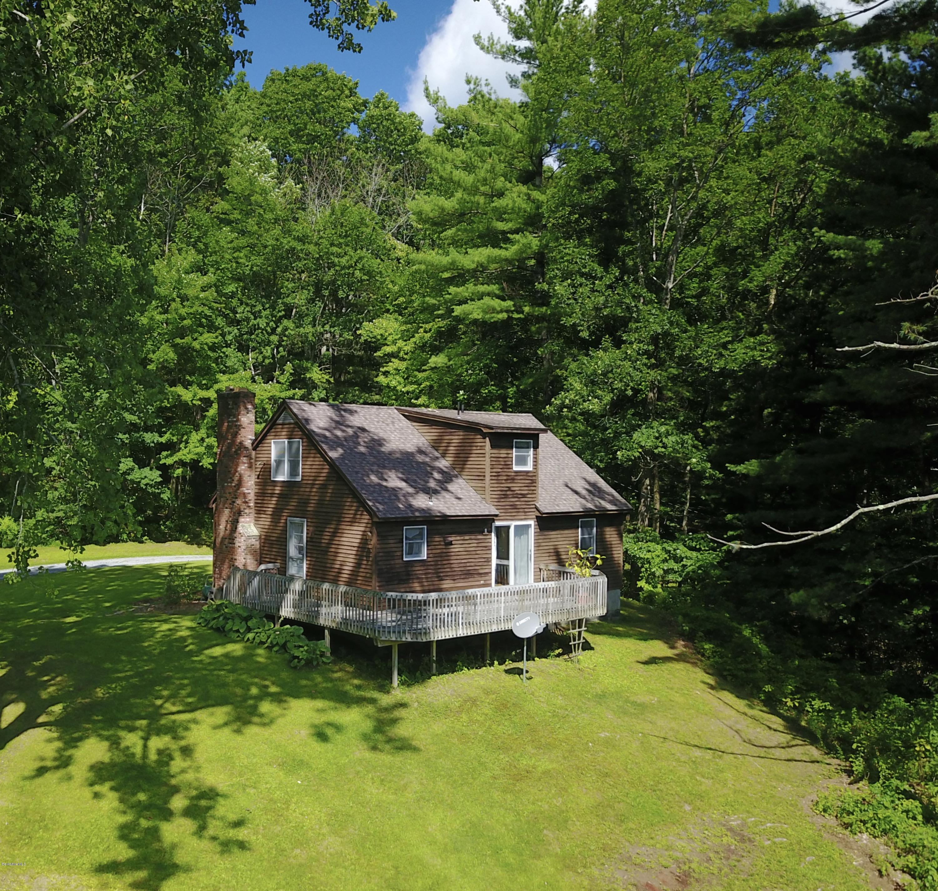 51 Main Road Monterey, MA 01230 - Photo 14 of 17 a view of a wooden house with a yard