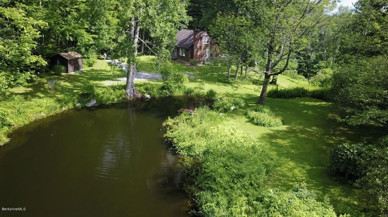 51 Main Road Monterey, MA 01230 - Photo 17 of 17 a backyard of a house with lots of green space and lake view