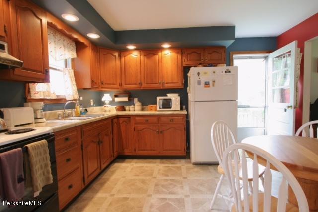 51 Main Road Monterey, MA 01230 - Photo 6 of 17 a kitchen with refrigerator a sink and a large window