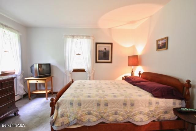 51 Main Road Monterey, MA 01230 - Photo 8 of 17 a bedroom with a bed and wooden floor