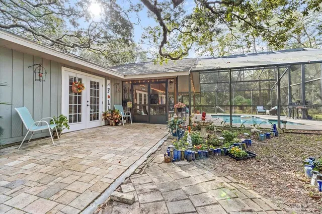 a view of a chair and table in backyard of the house