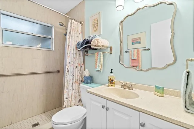 a bathroom with a window and a shower