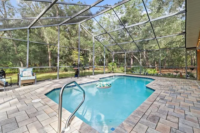 a view of backyard with a large tree
