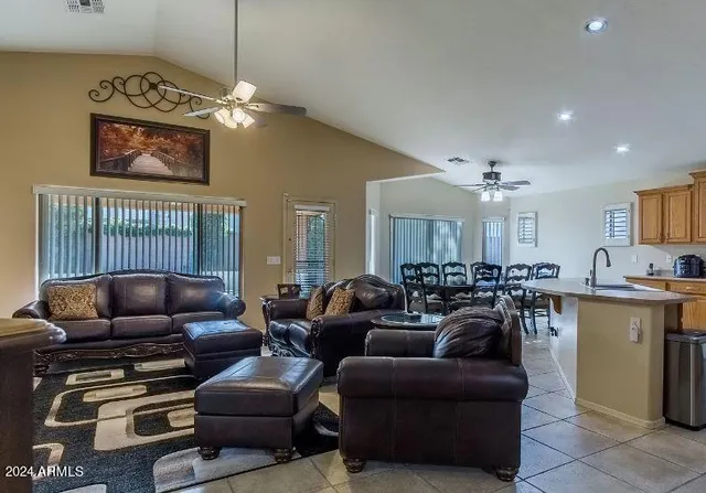 a living room with furniture kitchen and a chandelier