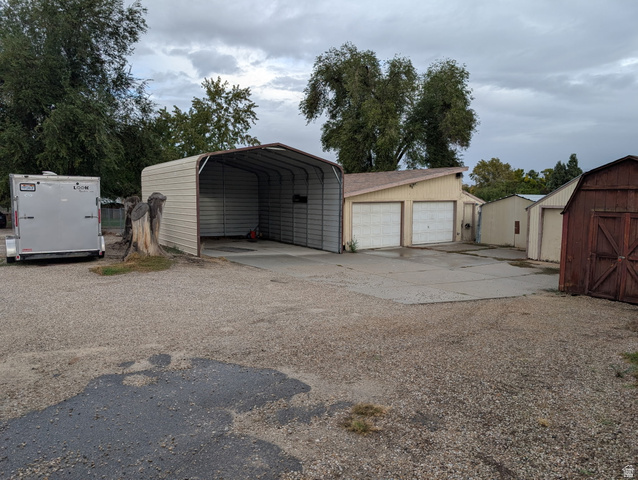 1341 East Crk Road Sandy, UT 84093 - Photo 7 of 24 Detached garage featuring a shed and driveway
