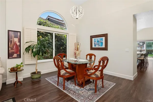 a living room with furniture a chandelier and a window