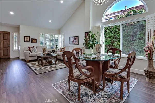 a living room with furniture a chandelier and a table