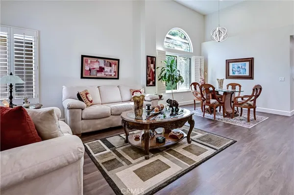 a living room with furniture a rug and a large window
