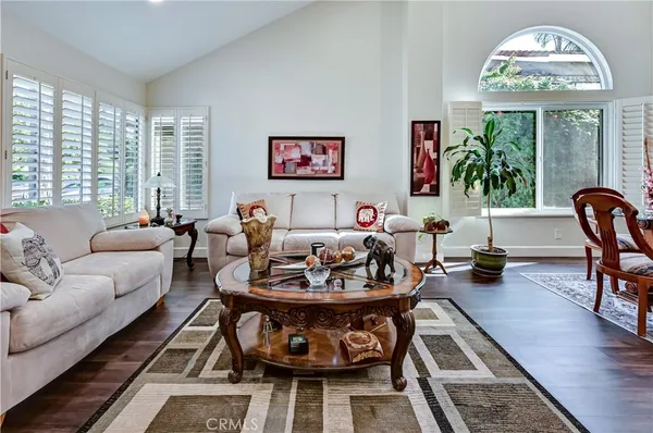 a living room with furniture a rug and a flat screen tv