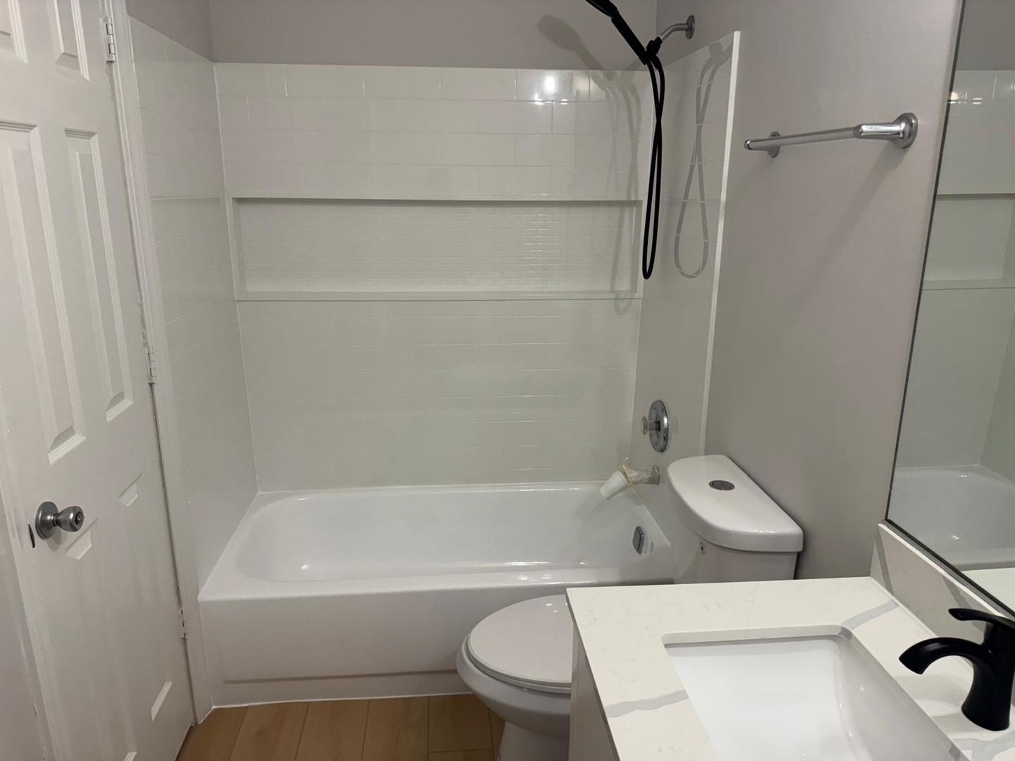 1935 North Hicks Road, Unit 106 Palatine, IL 60074 - Photo 14 of 16 a bathroom with a toilet and a bathtub