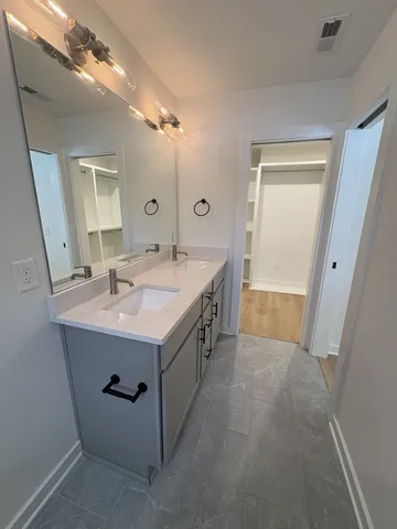 a spacious bathroom with a sink a mirror and a bathtub