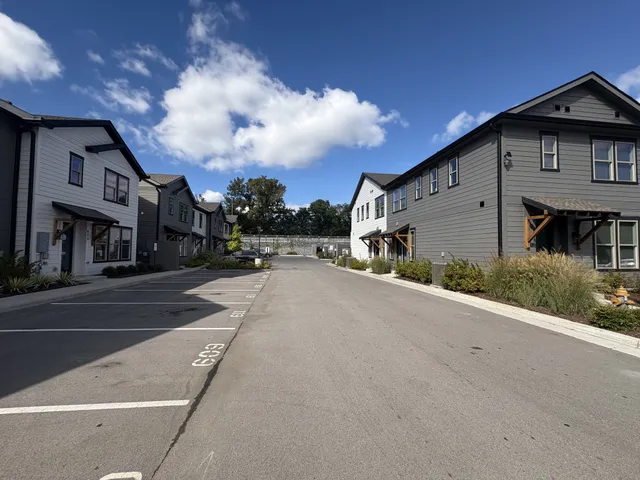 a view of a street with a building in the background