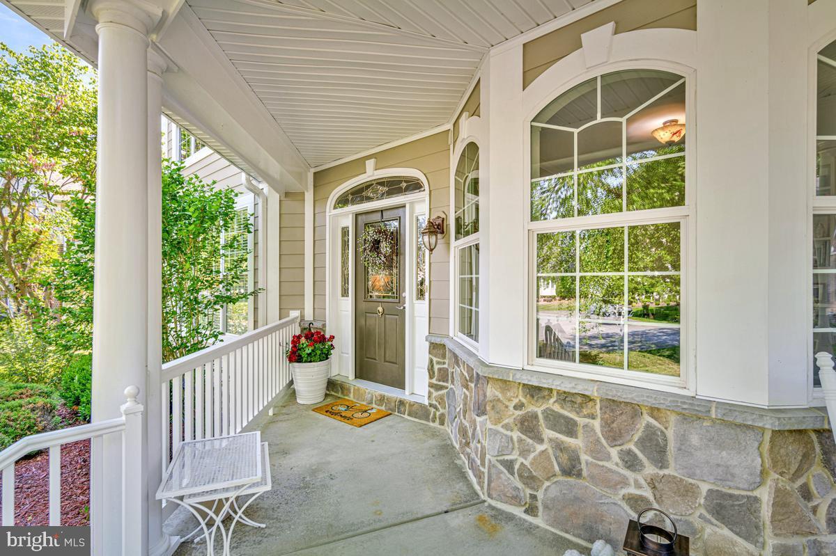 11565 Magnolia Court Issue, MD 20645 - Photo 5 of 68 a view of a porch with wooden floor and outdoor seating
