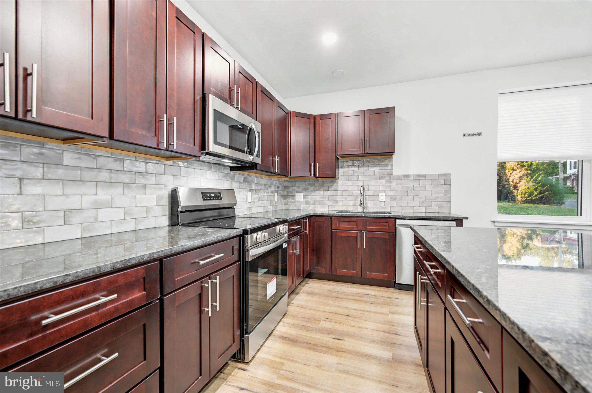 514 Ryers Avenue, Unit A Cheltenham, PA 19012 - Photo 7 of 18 Modern kitchen with rich cabinetry.