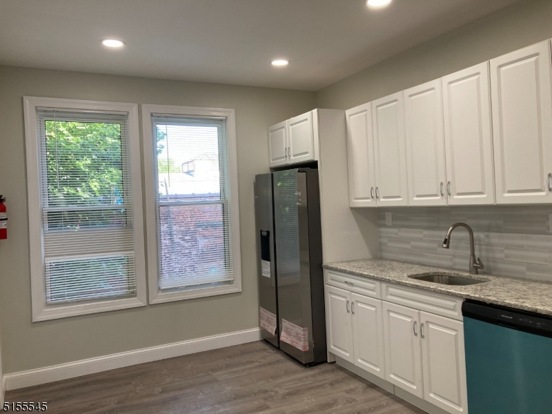 a kitchen with stainless steel appliances granite countertop a refrigerator sink and cabinets