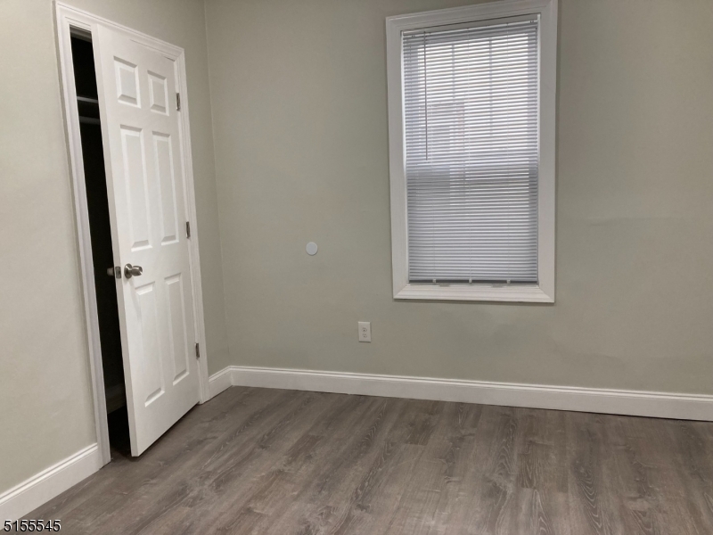 134 South 7th Street, Unit 2 Newark, NJ 07107 - Photo 13 of 13 an empty room with wooden floor and a window