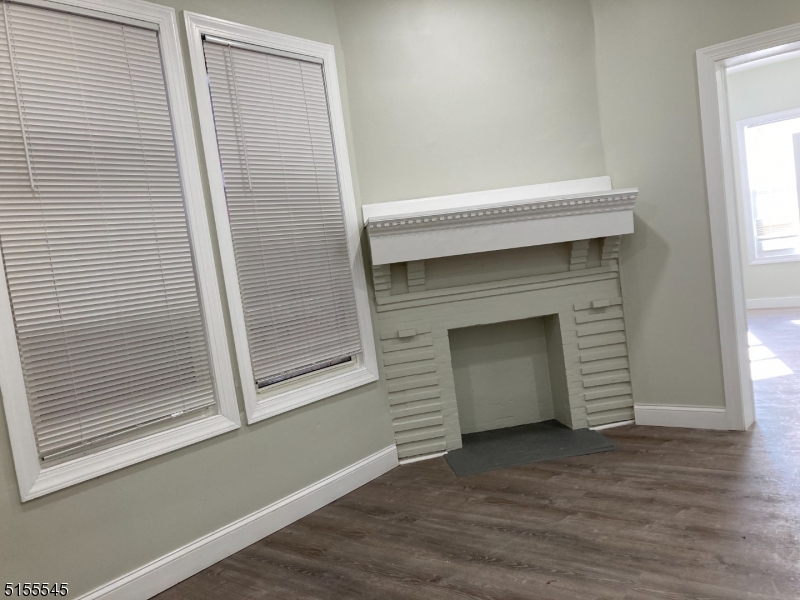 134 South 7th Street, Unit 2 Newark, NJ 07107 - Photo 3 of 13 a view of a hallway with wooden floor and a fireplace
