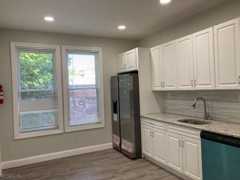 134 South 7th Street, Unit 2 Newark, NJ 07107 - Photo 5 of 13 a kitchen with stainless steel appliances granite countertop a refrigerator sink and cabinets