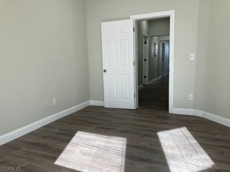 134 South 7th Street, Unit 2 Newark, NJ 07107 - Photo 6 of 13 an empty room with wooden floor and closet