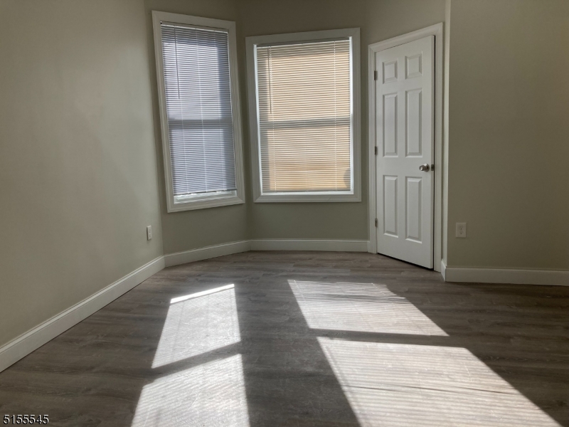 134 South 7th Street, Unit 2 Newark, NJ 07107 - Photo 8 of 13 a view of an empty room with wooden floor and a window