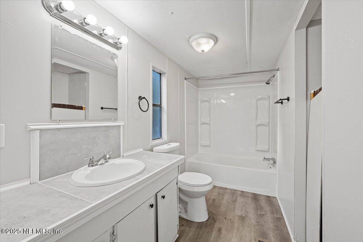 1480 Brangus Road Middleburg, FL 32068 - Photo 15 of 24 a bathroom with a sink toilet a shower and a mirror