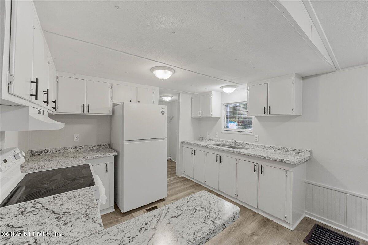 1480 Brangus Road Middleburg, FL 32068 - Photo 10 of 24 a kitchen with a sink a refrigerator and a stove