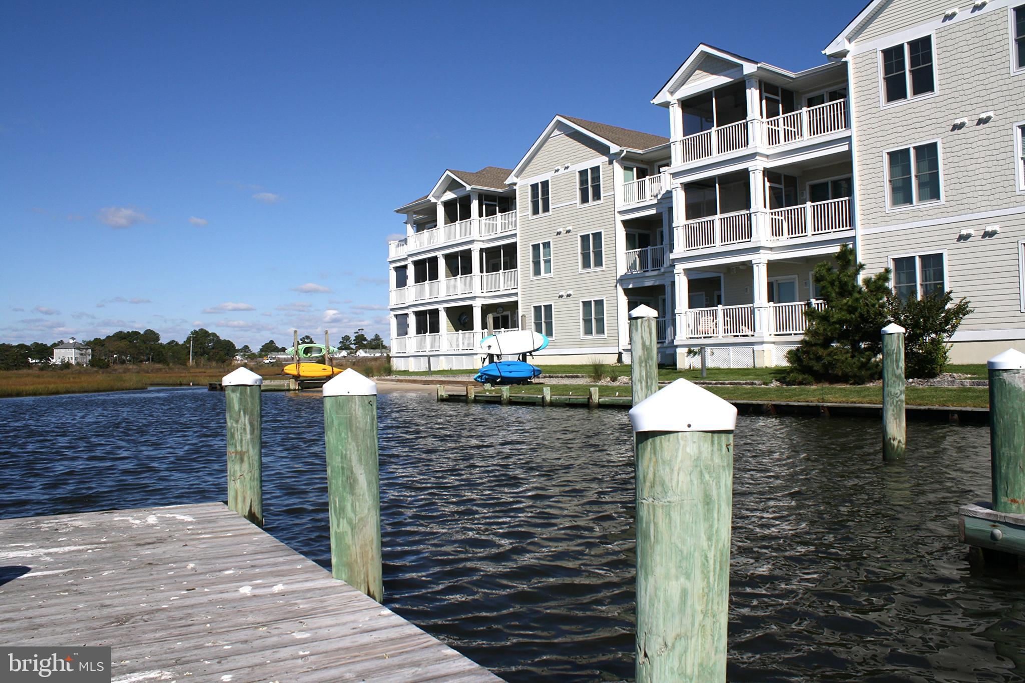 a front view of a building with lake view and tall building