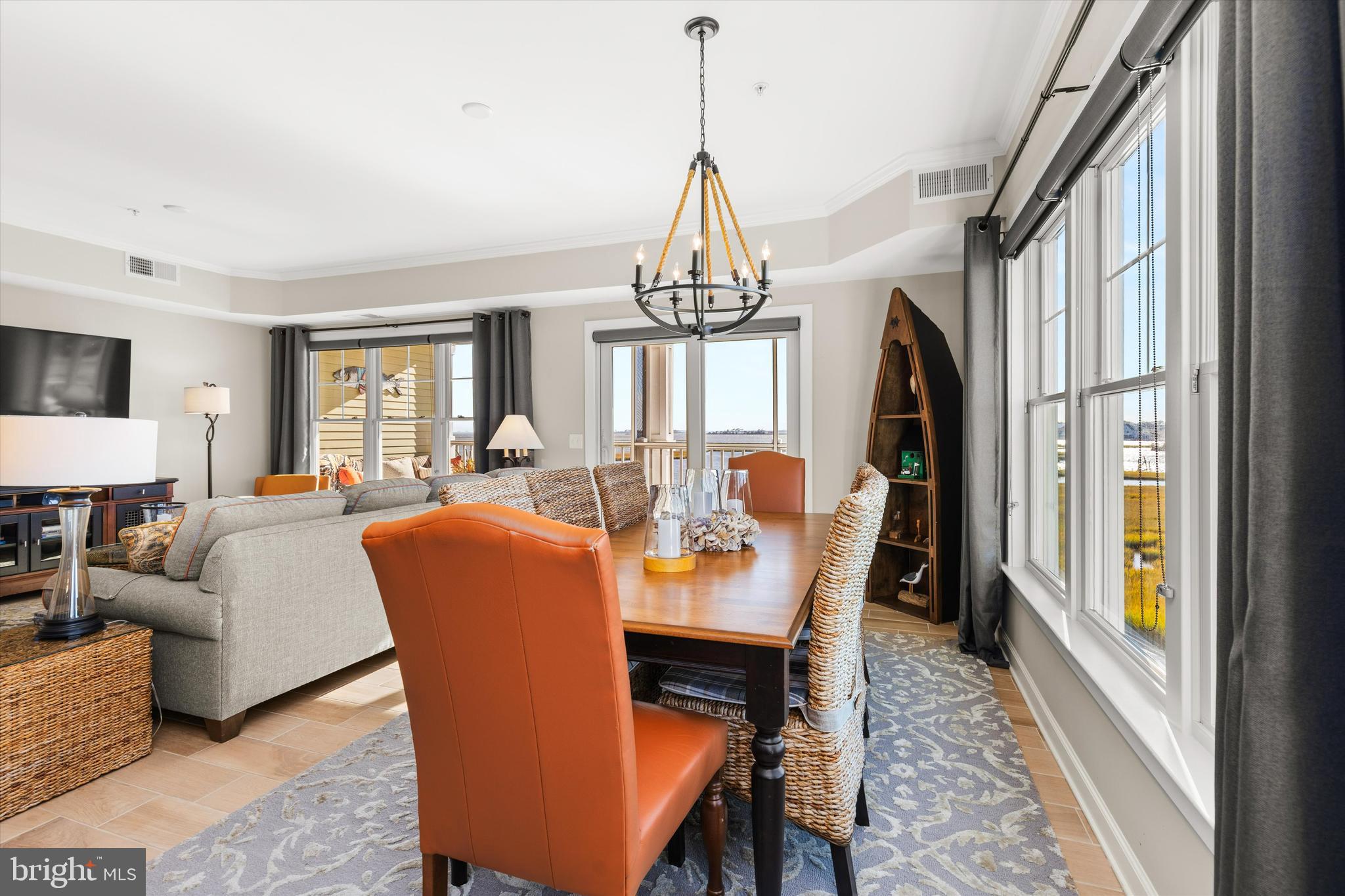 37286 Lighthouse Road, Unit 210 Selbyville, DE 19975 - Photo 11 of 75 a dining room with furniture a chandelier and wooden floor