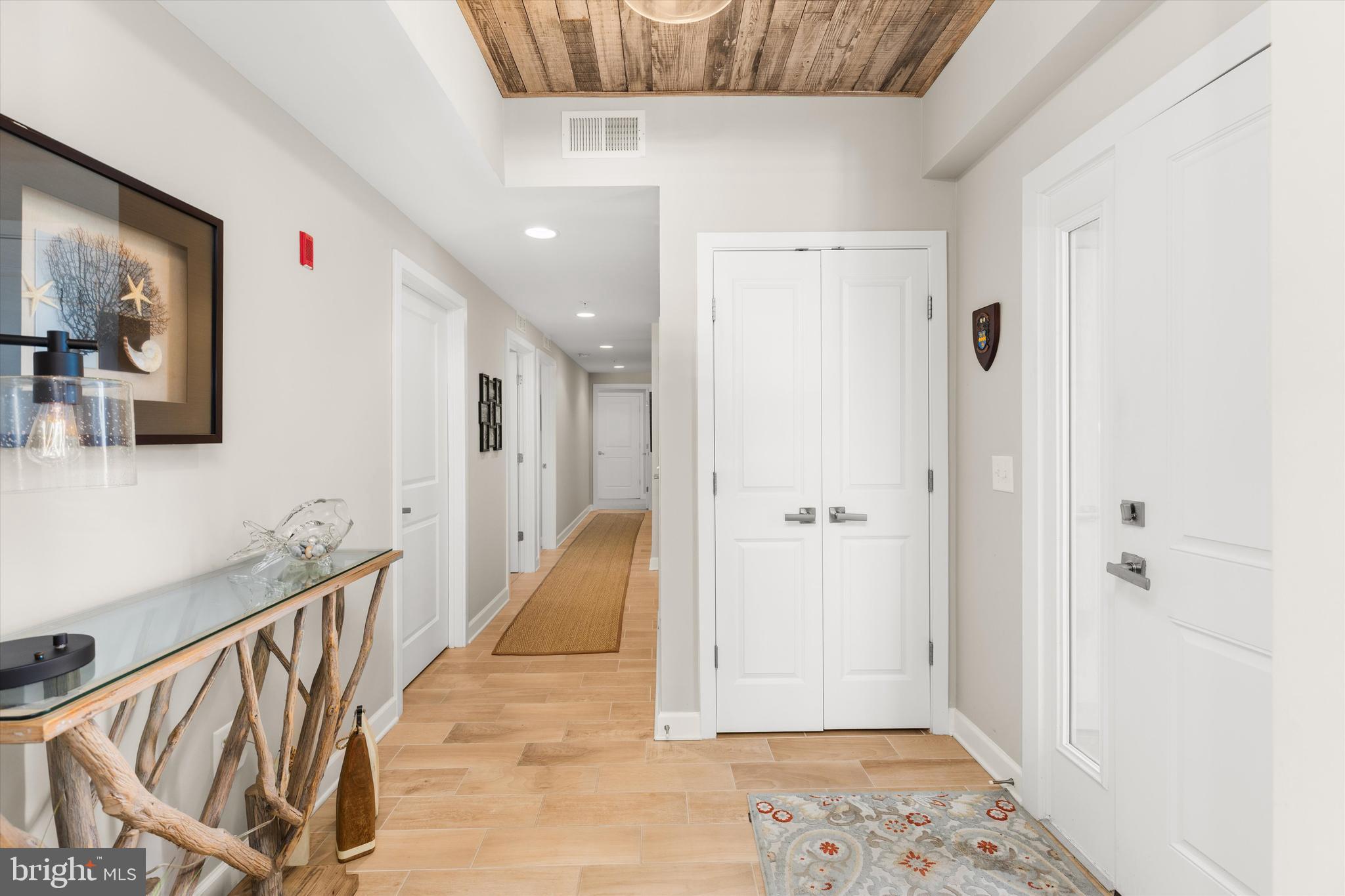 37286 Lighthouse Road, Unit 210 Selbyville, DE 19975 - Photo 26 of 75 a view of a hallway with wooden floor and staircase
