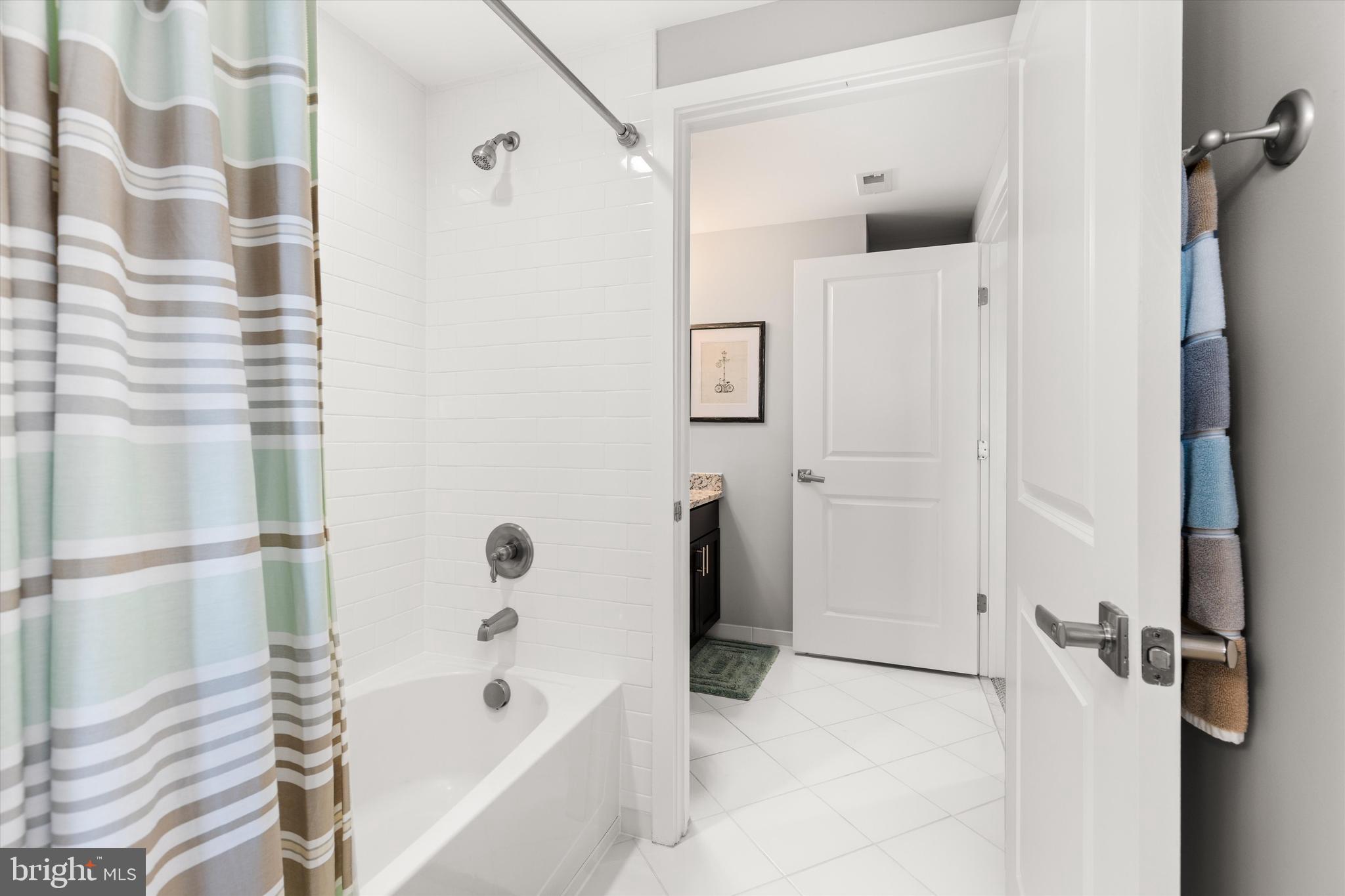 37286 Lighthouse Road, Unit 210 Selbyville, DE 19975 - Photo 30 of 75 a bathroom with a bathtub and a shower
