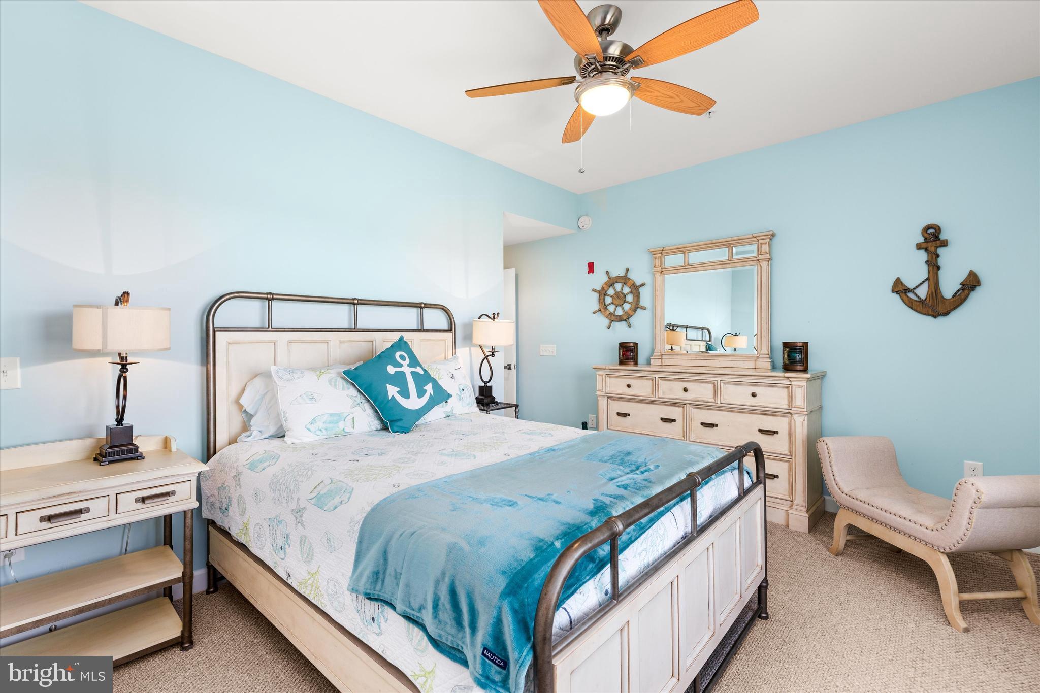 37286 Lighthouse Road, Unit 210 Selbyville, DE 19975 - Photo 38 of 75 a bedroom with a bed and a chandelier