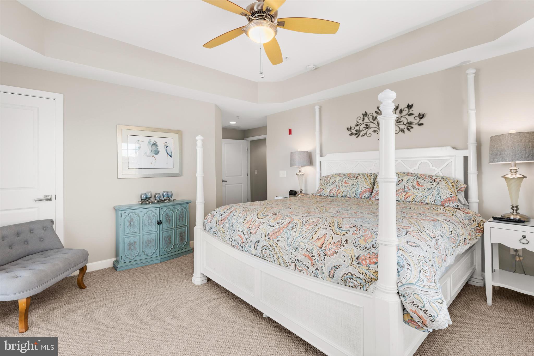 37286 Lighthouse Road, Unit 210 Selbyville, DE 19975 - Photo 42 of 75 a bedroom with a bed and a chandelier