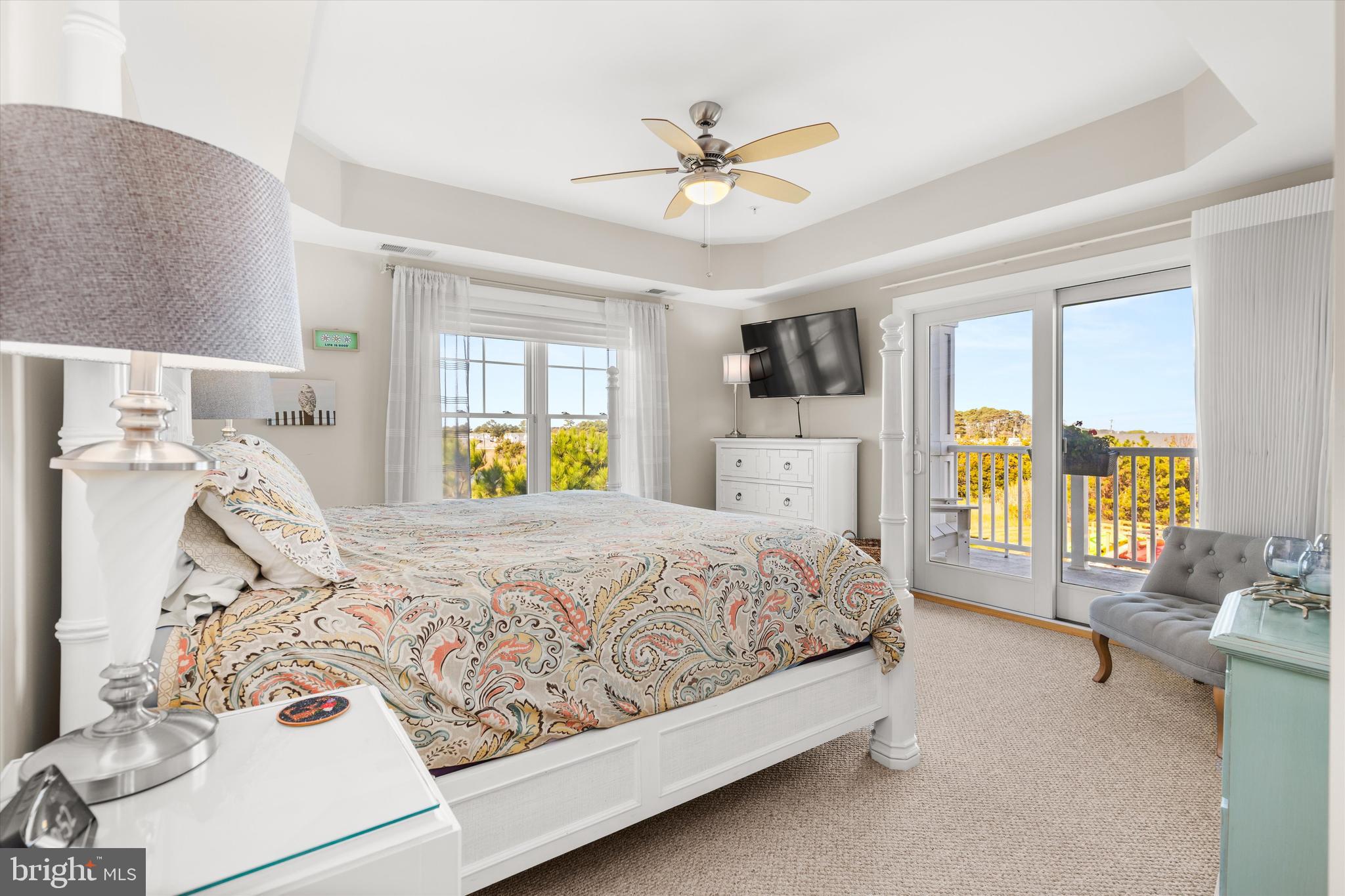37286 Lighthouse Road, Unit 210 Selbyville, DE 19975 - Photo 43 of 75 a bedroom with a large bed and a chandelier