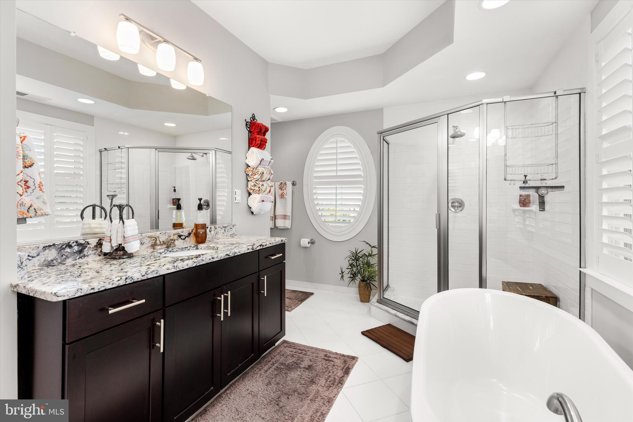 37286 Lighthouse Road, Unit 210 Selbyville, DE 19975 - Photo 44 of 75 a spacious bathroom with a tub sink mirror and vanity