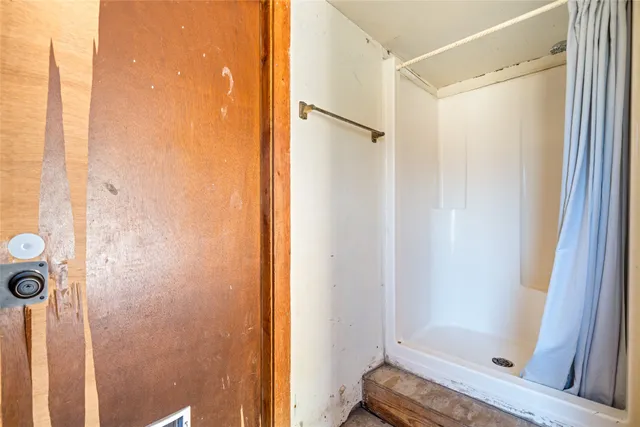 a bathroom with a glass door shower