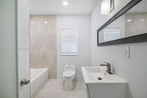 a bathroom with a bathtub and shower