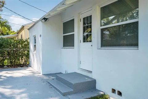a view of a backyard with plants and trees